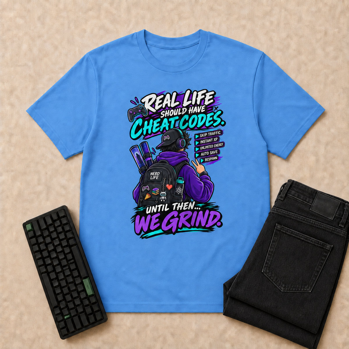 Real Life Nerd Life T-Shirt — Carolina Blue overhead flat-lay with keyboard and double-folded jeans