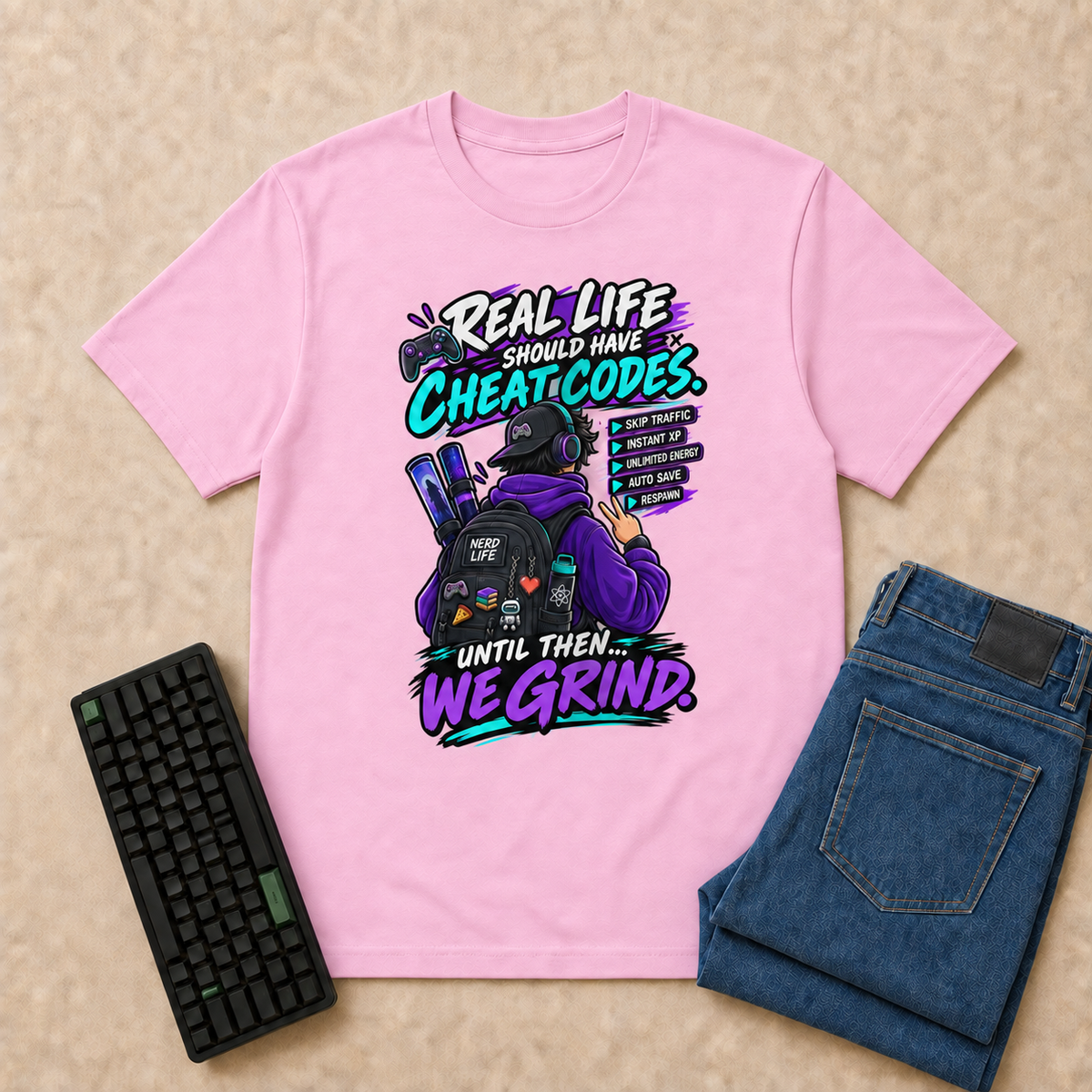 Real Life Nerd Life T-Shirt — Light Pink overhead flat-lay with keyboard and double-folded jeans